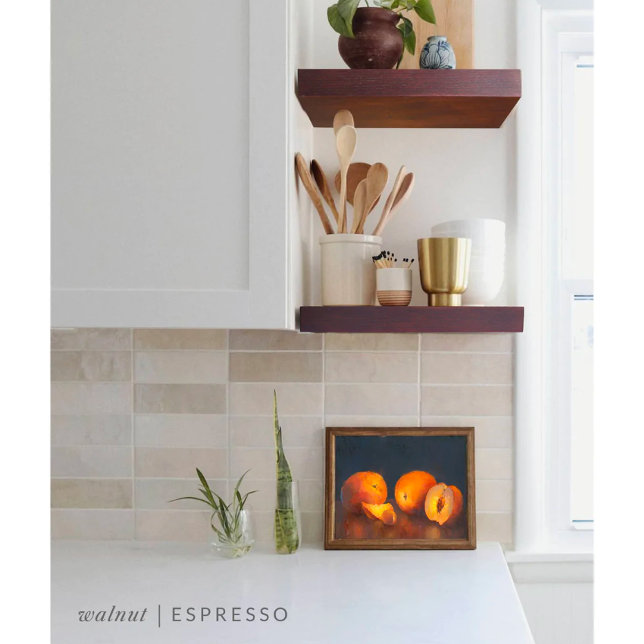 Walnut floating shelves in a kitchen with the espresso finish applied decorated with kitchen utensils, a plant, charcuterie board, and vases