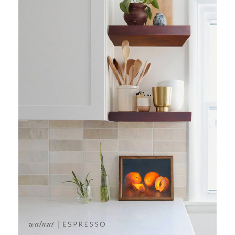 Walnut floating shelves in a kitchen with the espresso finish applied decorated with kitchen utensils, a plant, charcuterie board, and vases