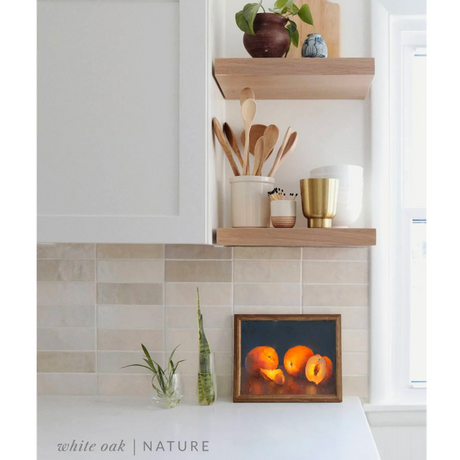 white oak floating shelves in a kitchen with the nature finish applied decorated with kitchen utensils, a plant, charcuterie board, and vases