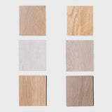 Six white oak wood square samples of different wood finishes on a white background
